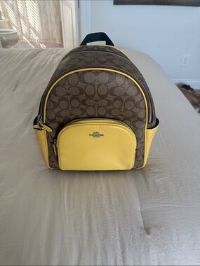 Coach Brown Signature Backpack with Yellow Leather Accents